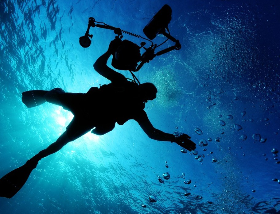 A scuba diver with a camera