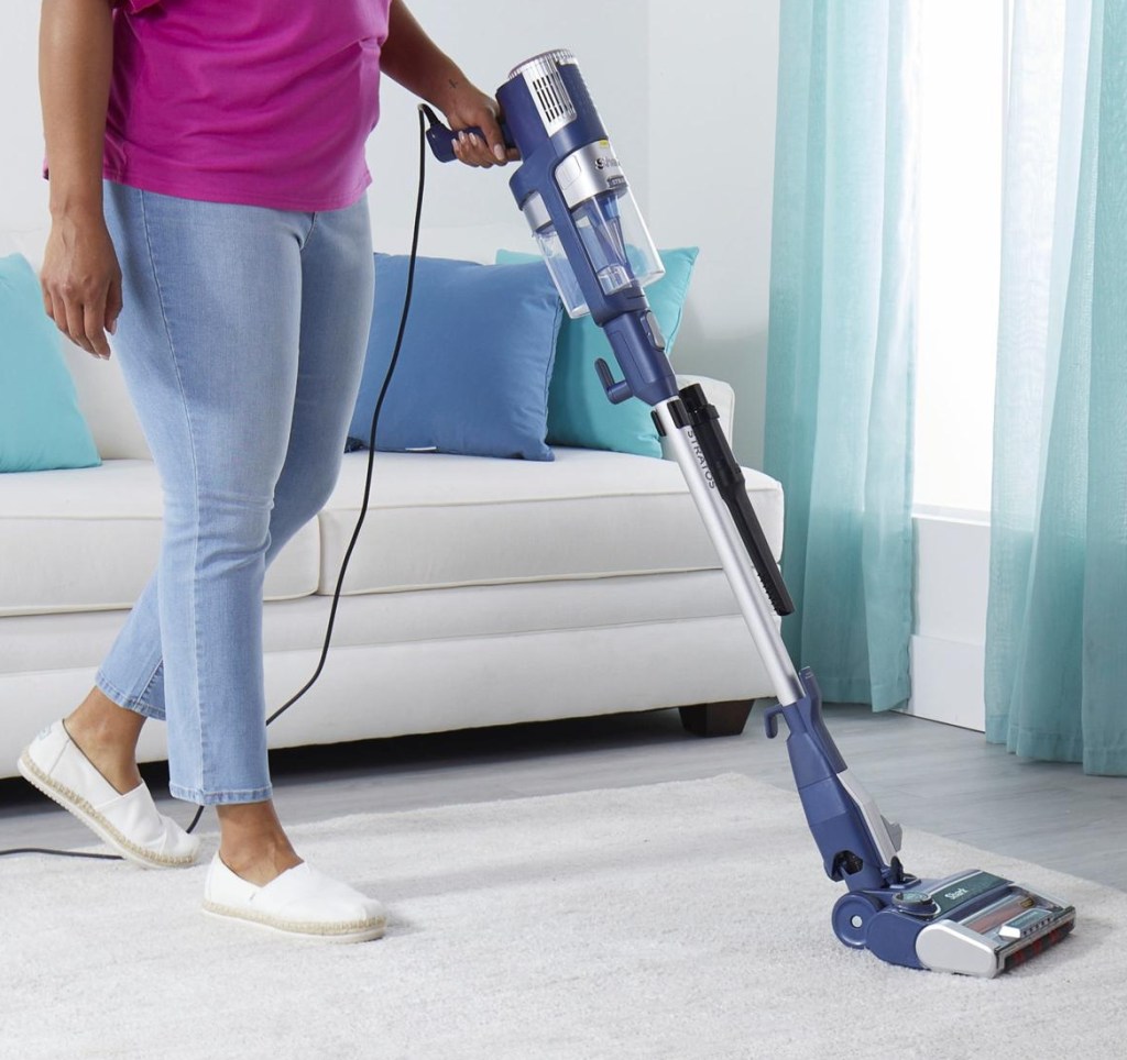 Woman using a Shark vacuum