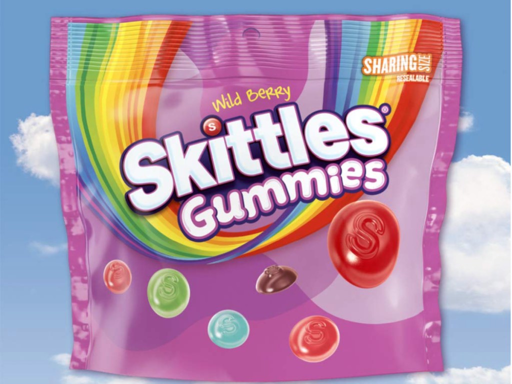 resealable bag of skittles gummies with sky background