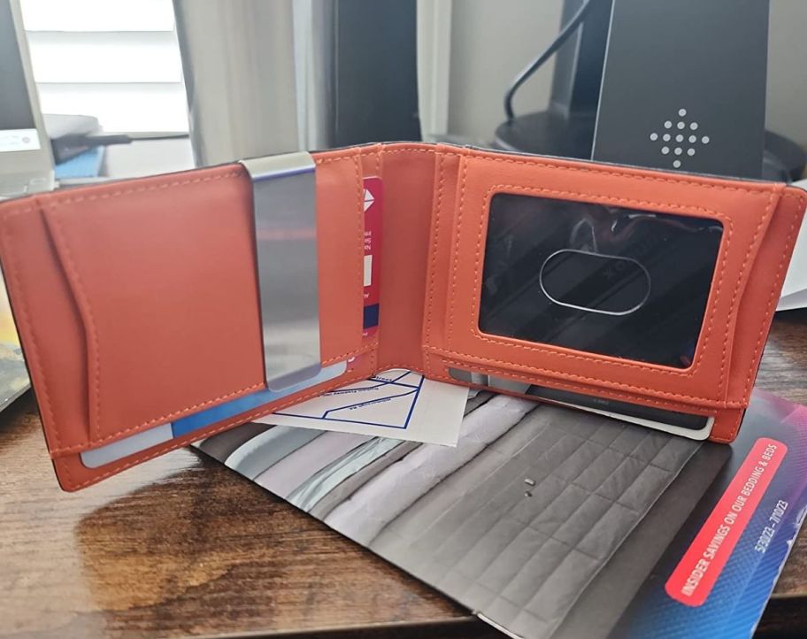 A Slim RFID Blocking Leather Wallet open on a table