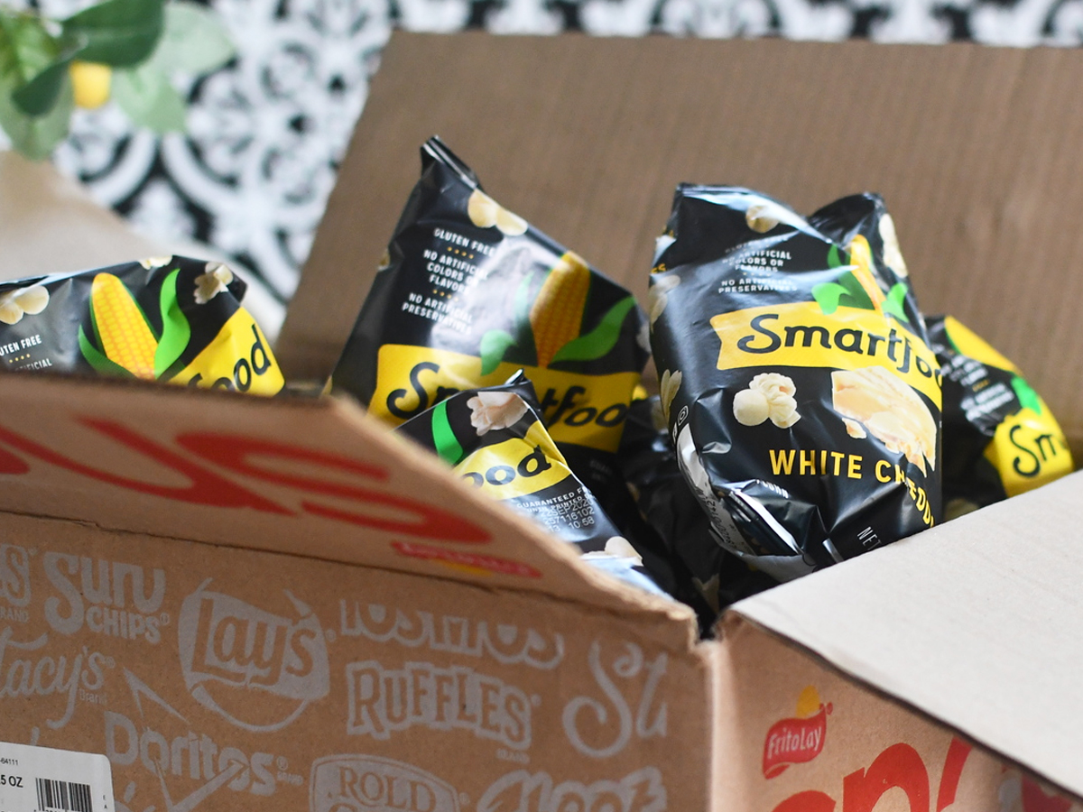 box full of Smartfood White Cheddar Popcorn snack bags