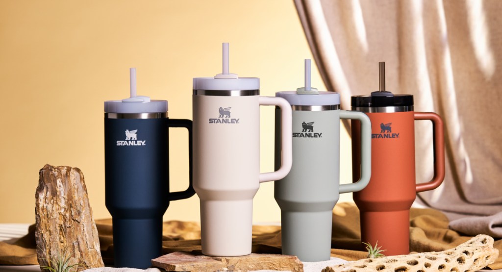 Stanley the quencher 2.0 tumbler in four different colors displayed in a photo studio