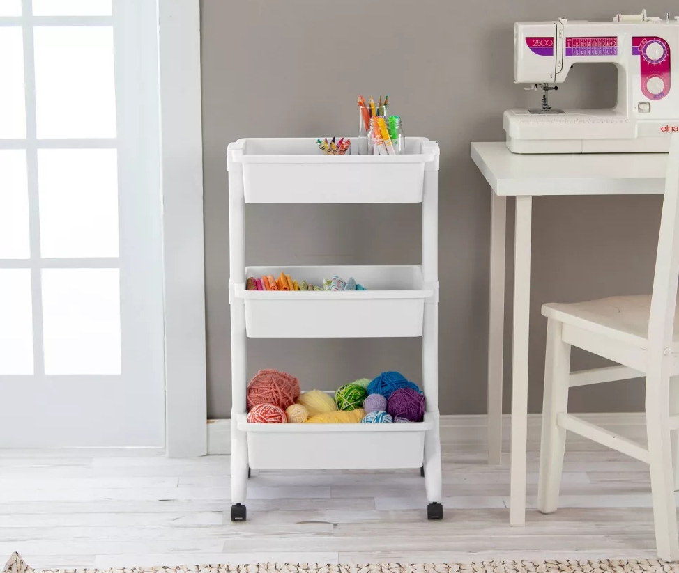 Three tier utility cart with craft supplies in it