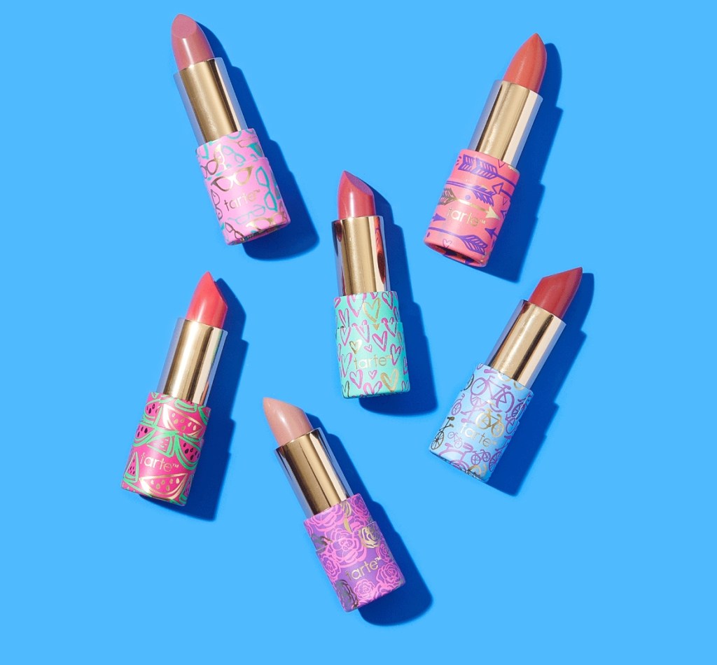 Group of Tarte lipsticks with a blue background behind them