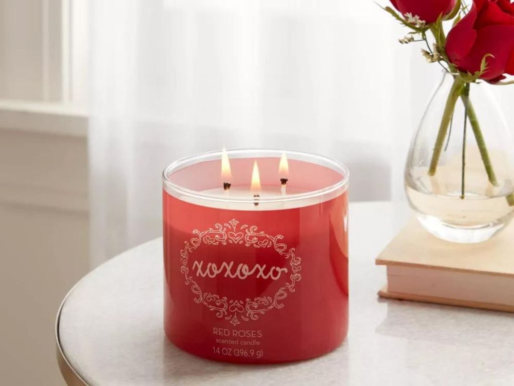 A Threshold 3-Wick 14oz Candle XOXO Red Roses on a table