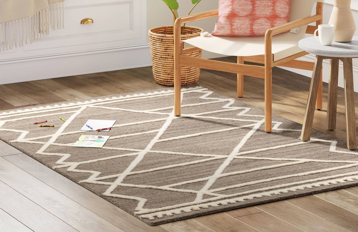 grey and white area rug under accent chair