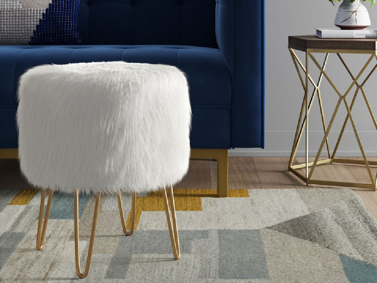 Threshold Radovre Hairpin Ottoman Faux Fur White with blue couch on the background