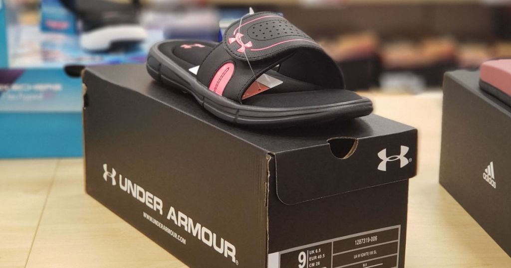 one Under Armour Ignite women's slide on top of the box they come in