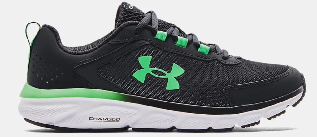 Black, green, and white Under Armour running shoe