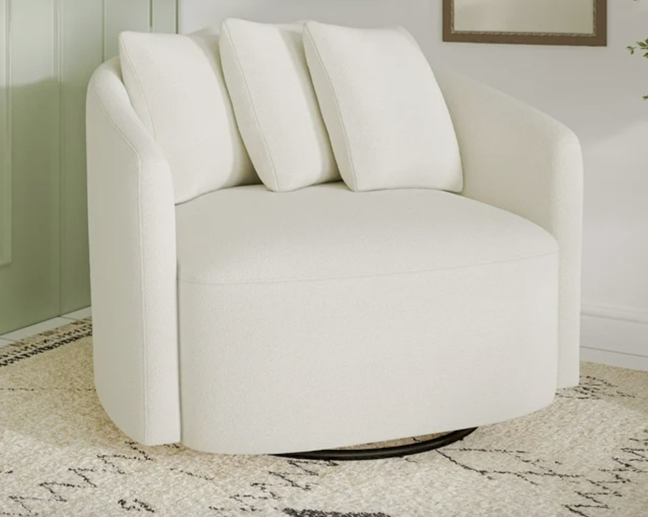 white swivel chair with pillows on rug