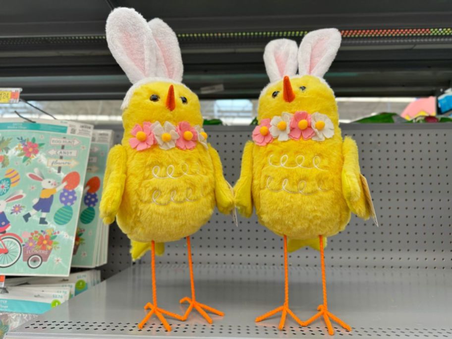 large, tall Easter decor birds chicks with bunny rabbit ears and flowers standing on shelf