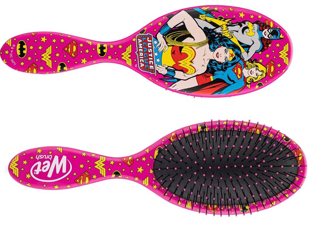 Hairbrush with pictures of Wonder Woman, Super Girl, and Batgirl
