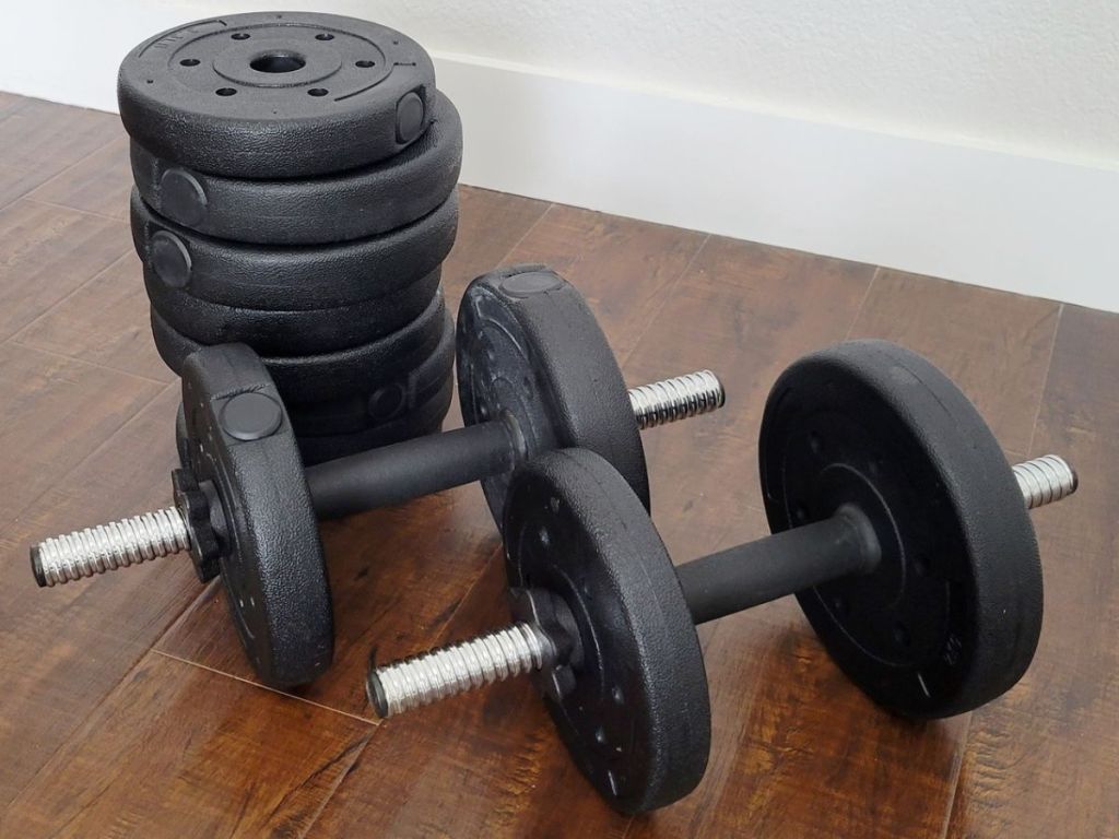 interhcangeable heavy dumbell set of 2 next to a stack of eight weights