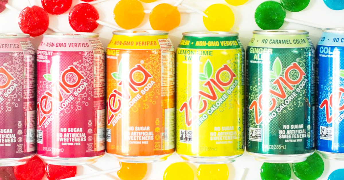 row of zevia sodas in rainbow order with lollipops around them