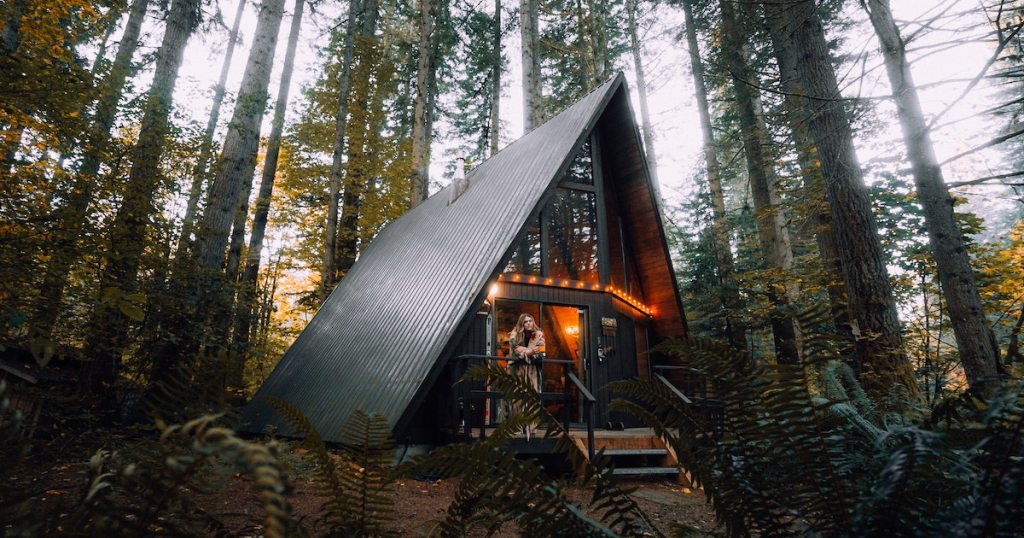 black a frame house with lights in woods airbnb essentials