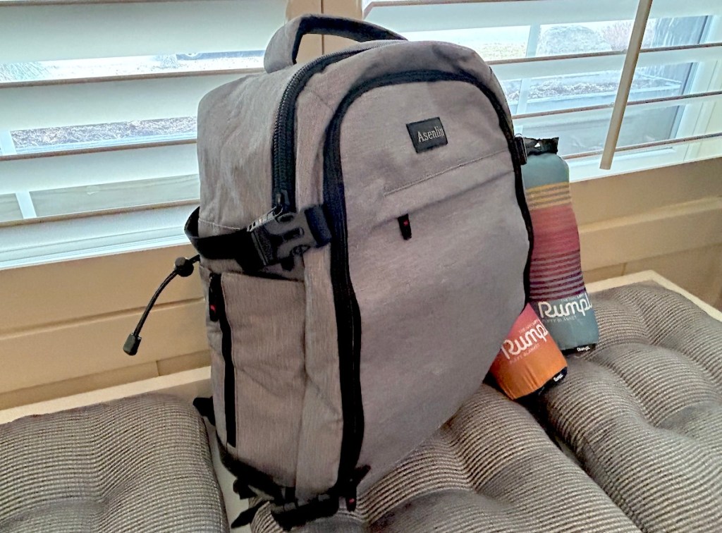gray travel backpack on bench