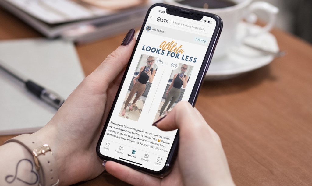 hands holding phone with athleta looks for less on screen