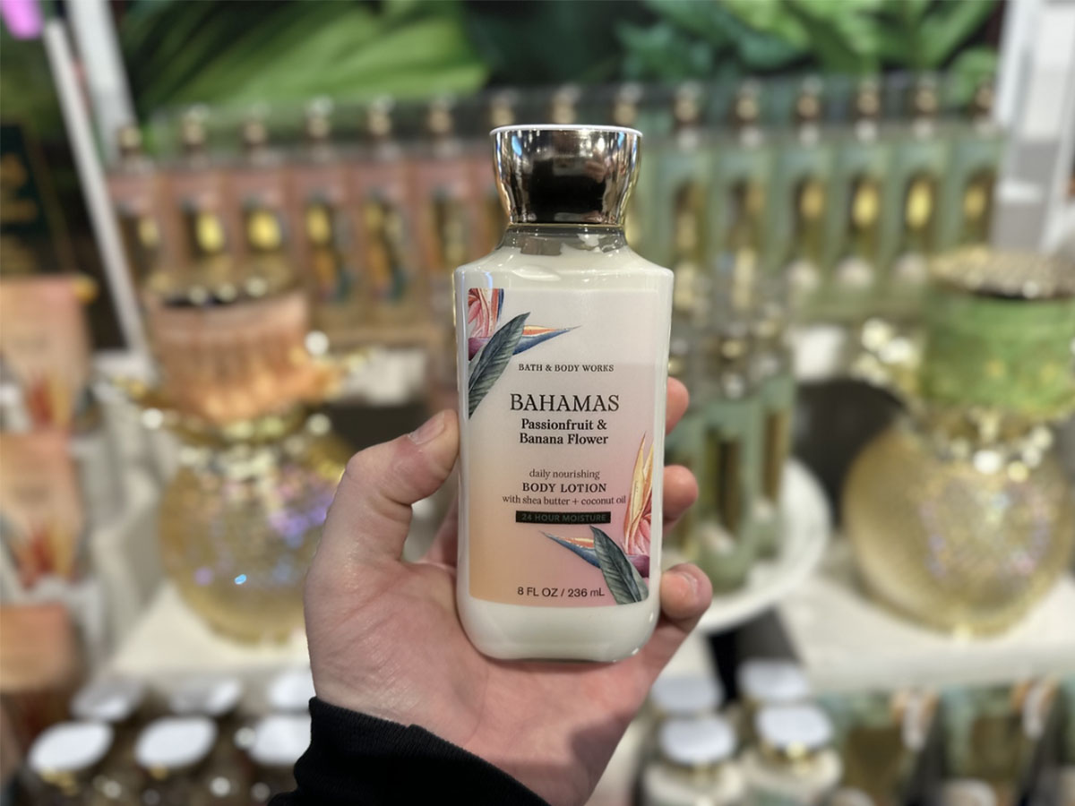 hand holding bahamas body lotion in bath and body works
