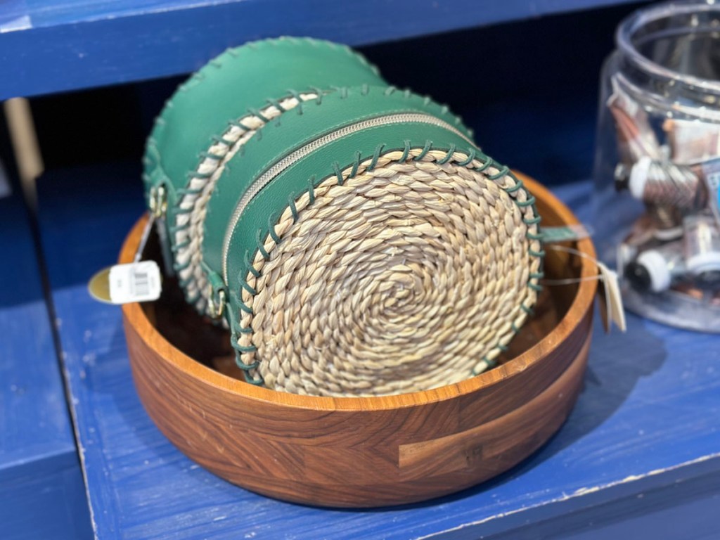 two round woven cosmetic bag in wooden bowl