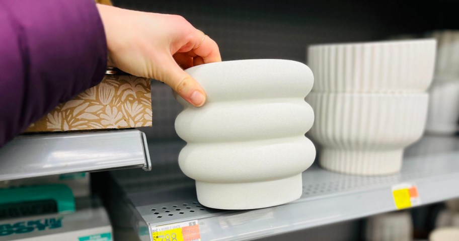 hand holding better homes and garden white bubble planter in walmart store