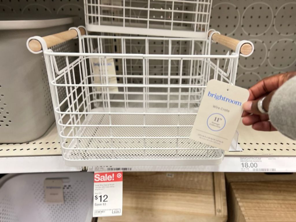 white wire basket with wood handles on store shelf