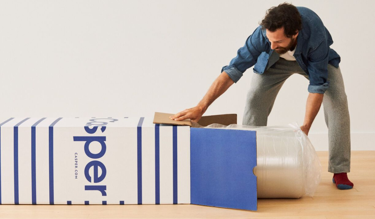 man removing mattress from box