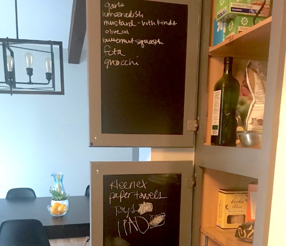 a chalkboard, one of our favorite pantry organization ideas, hanging on the back of a cabinet