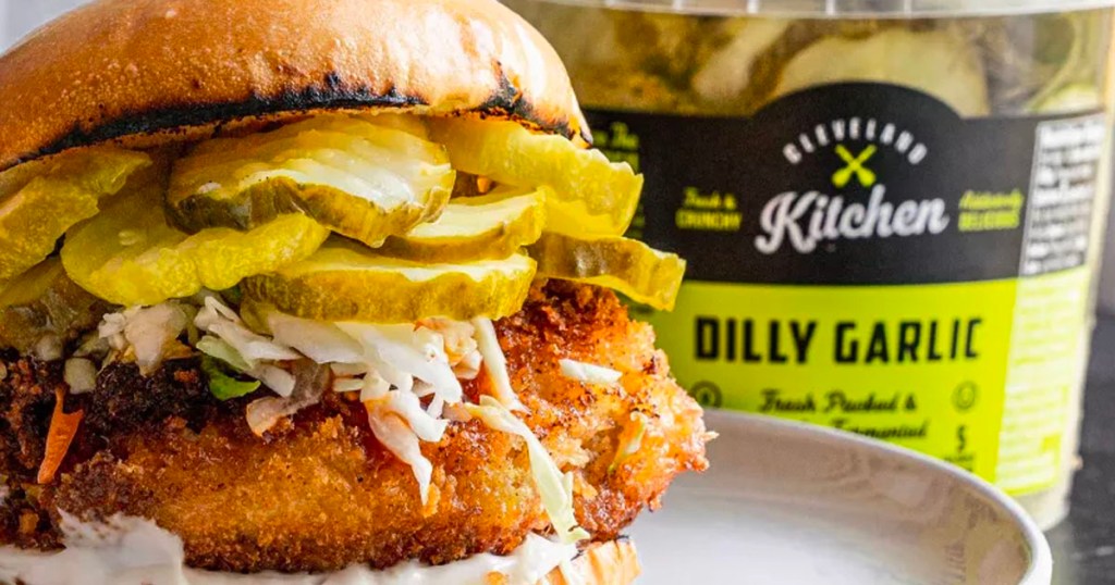 fried chicken sandwich with jar of cleveland pickles