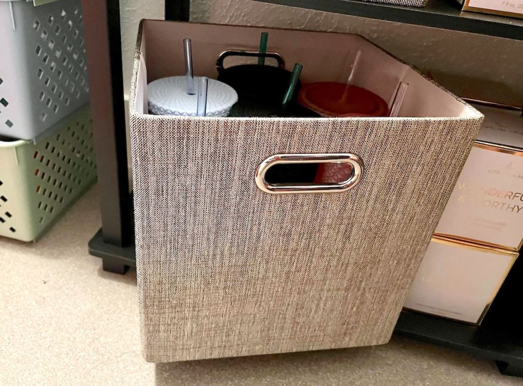 close up of gray cube bin with tumblers inside