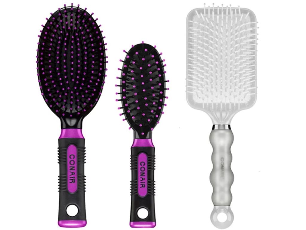 2 purple and black hair brushes and gray and white hairbrush