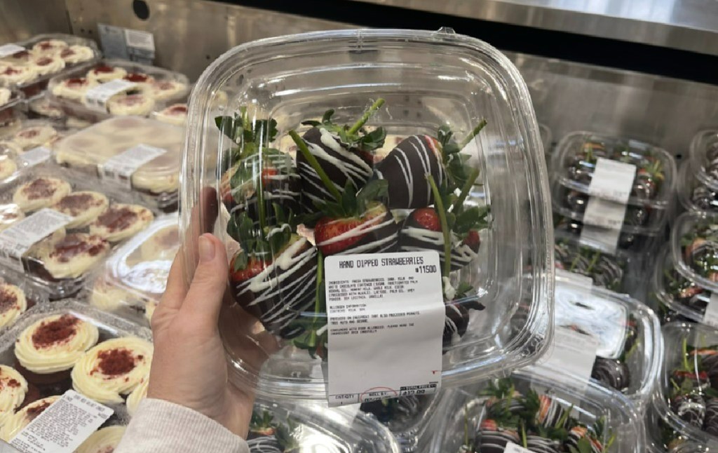 hand holding a package of chocolate dipped strawberries one of Costco's holiday treats for Valentines Day
