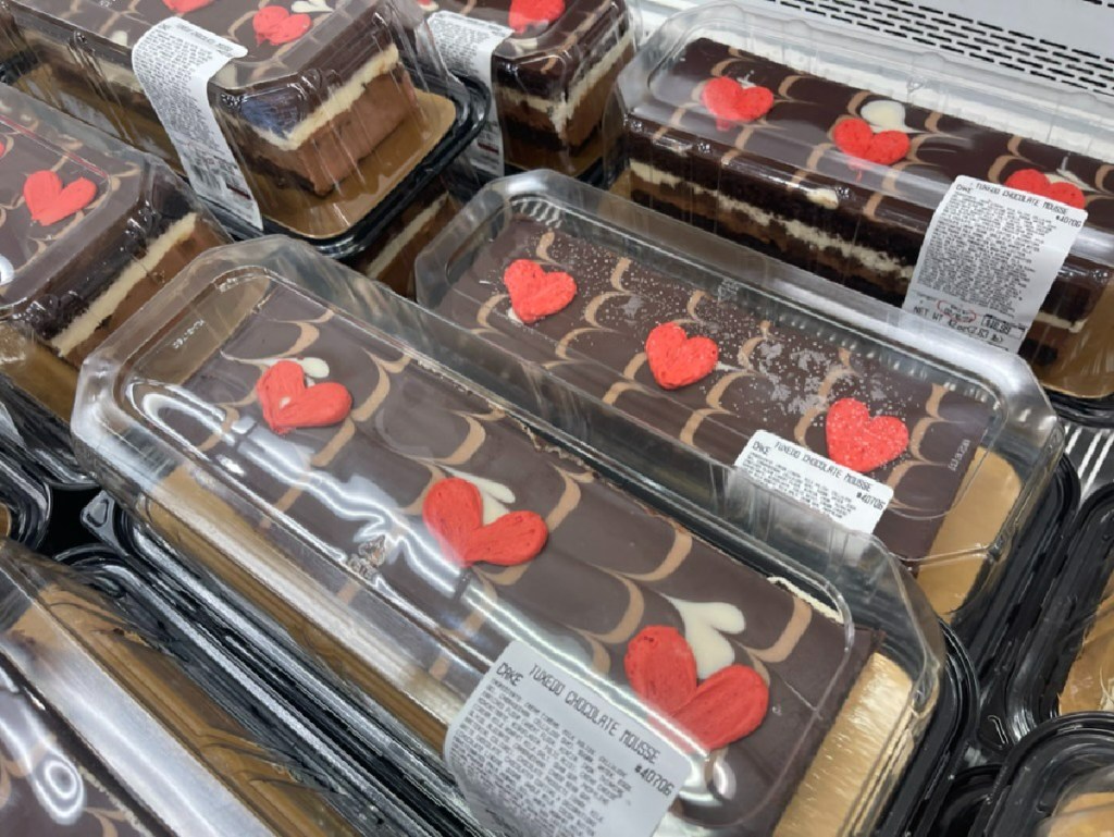 costco holiday treats on display in store including tuxedo cake