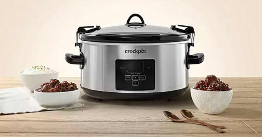 crockpot on table with bowls of food