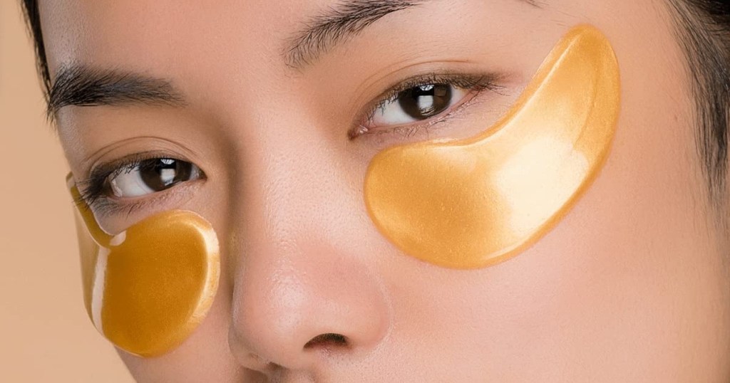 woman wearing 2 gold under-eye patches