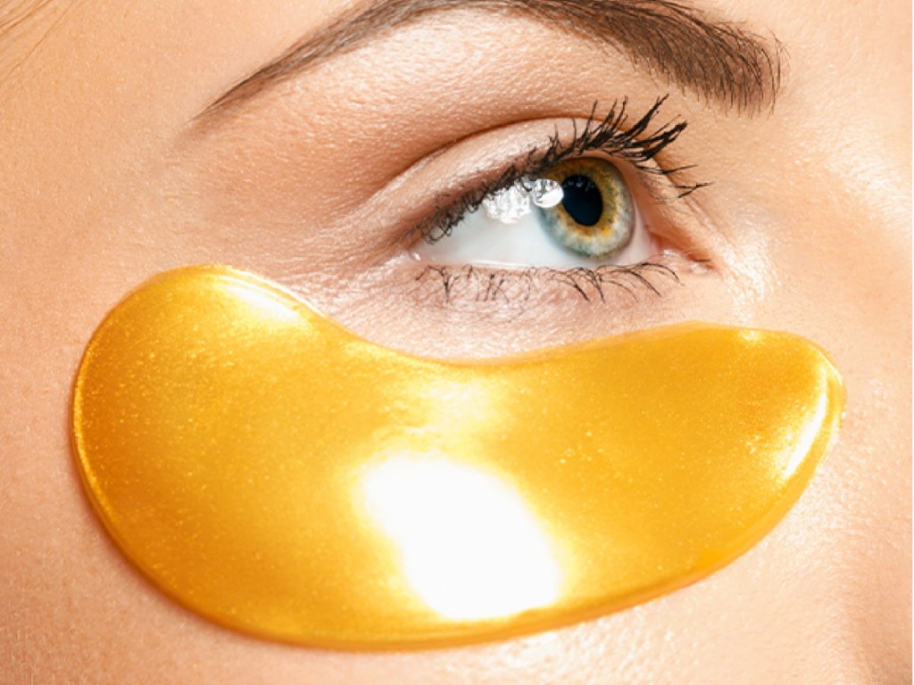 woman wearing gold under-eye patch