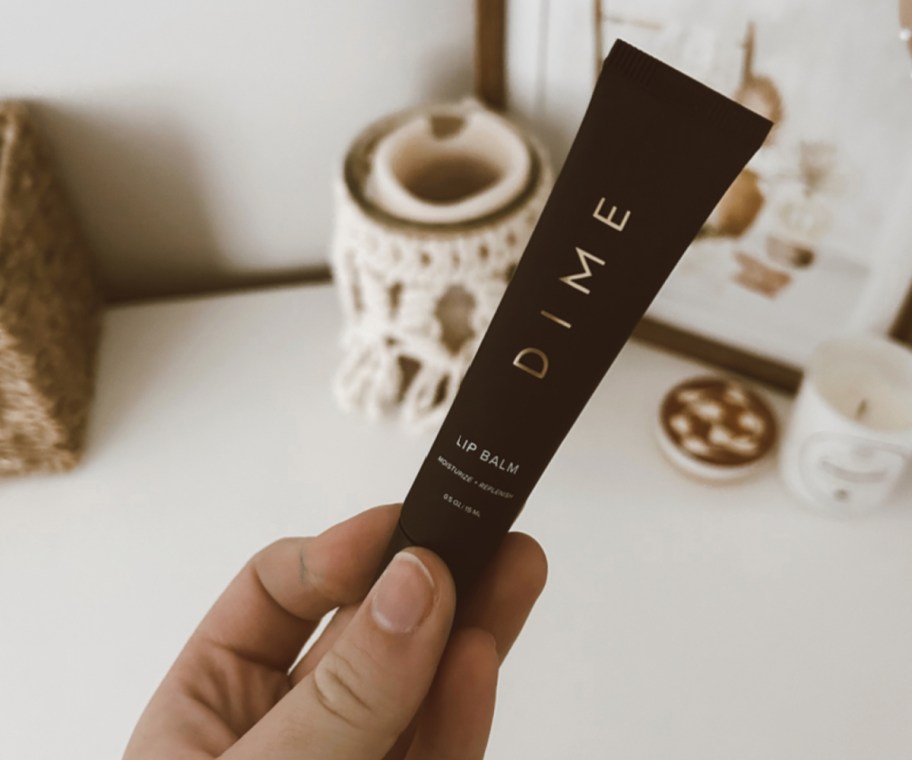 hand holding lip balm tube