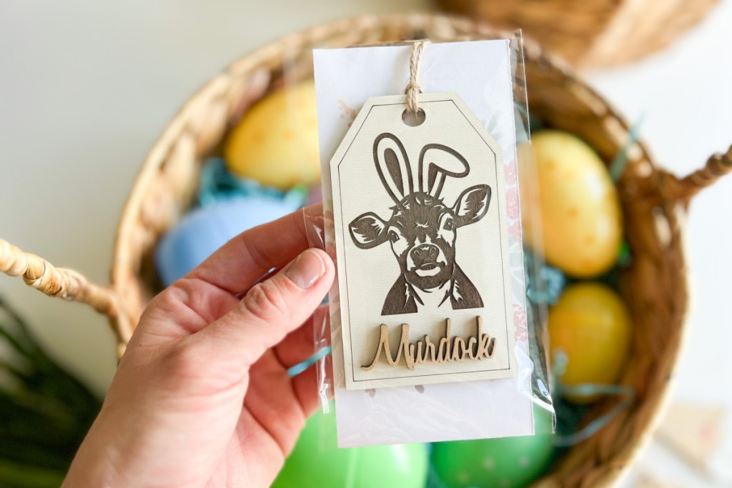 hand holding cow easter tag