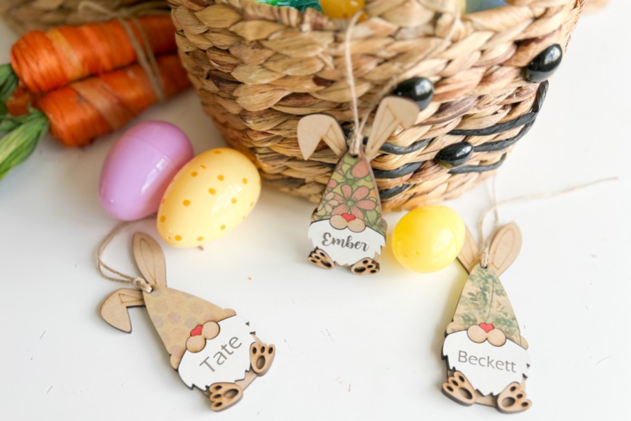 three gnome Easter tags next to basket and eggs