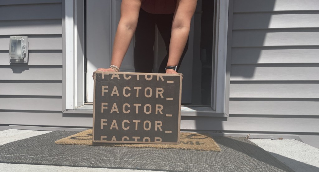 woman grabbing factor delivery box on doorstep