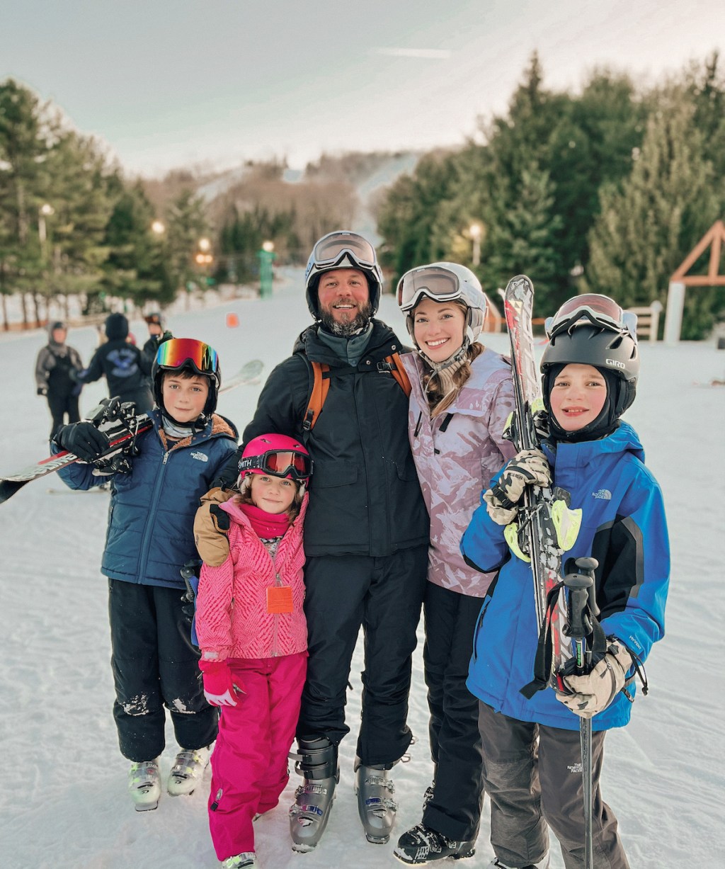 family wearing ski gear outside at resort