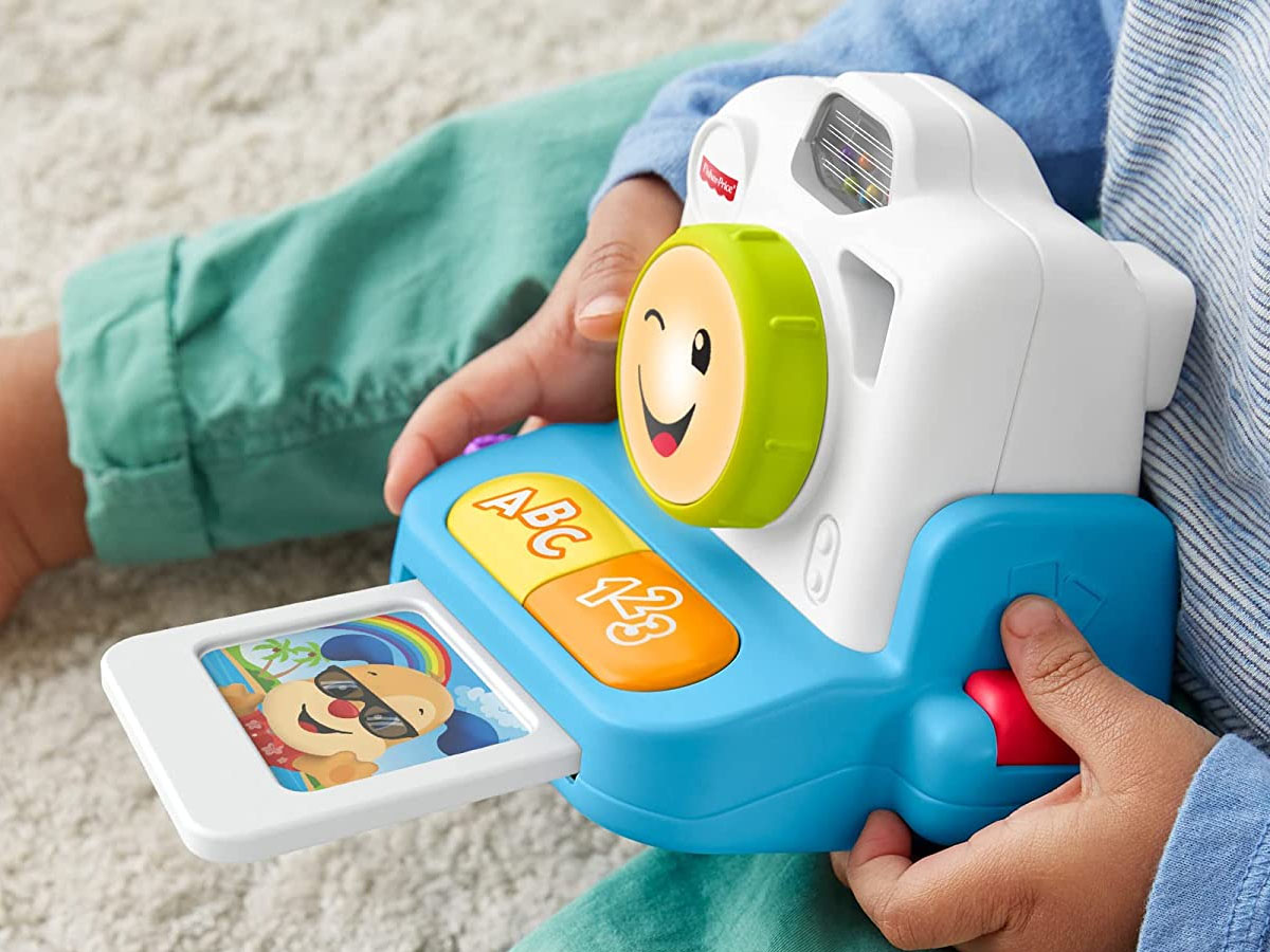 child playing with fisher price camera