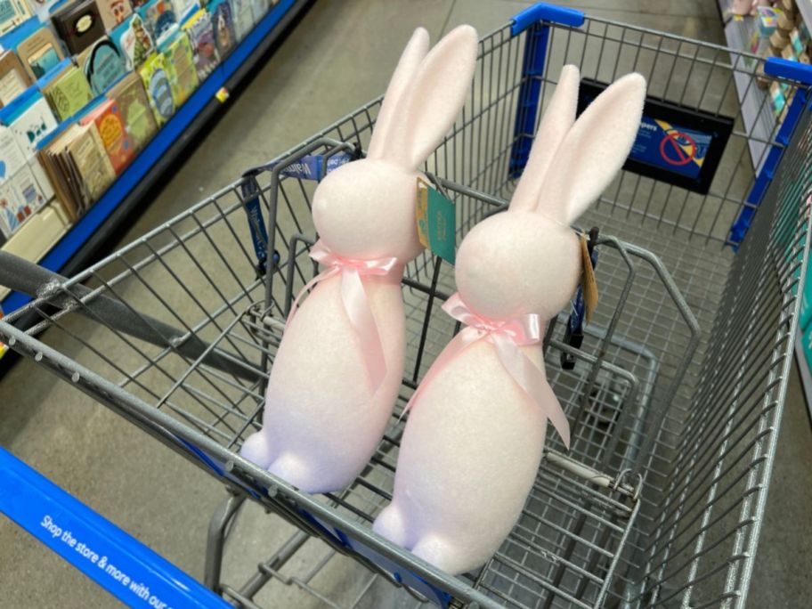 2 pink flocked bunny figures in a shopping cart