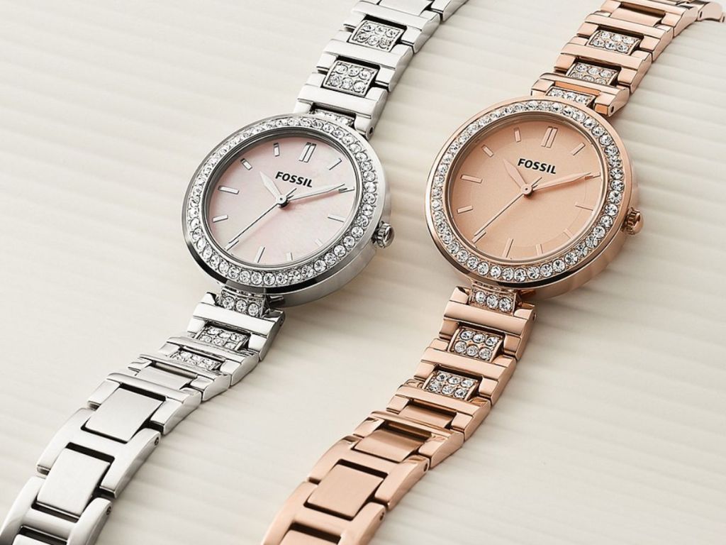silver and rose gold Fossil watches laying on white surface