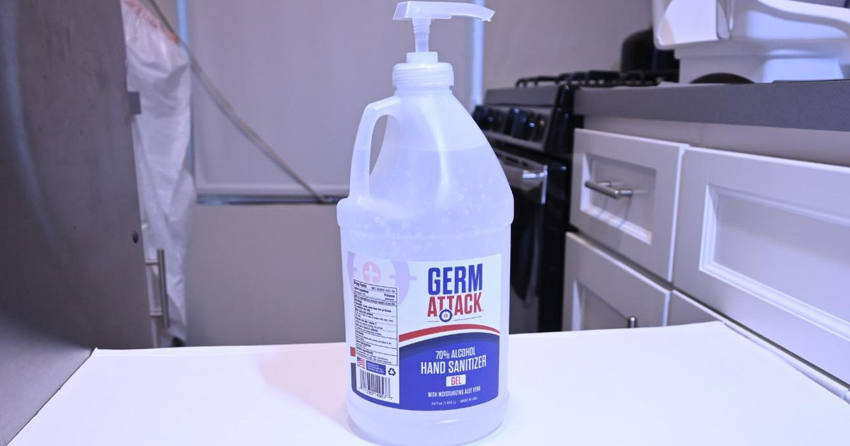 germ attack 1 gallon hand sanitizer on table in laundry room