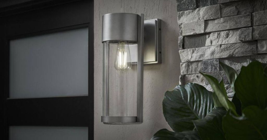 brushed nickel cylinder light sconce on wall