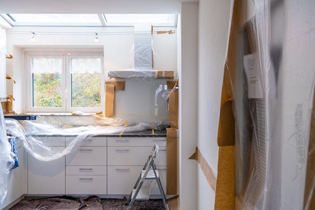 kitchen under renovation with plastic on counters