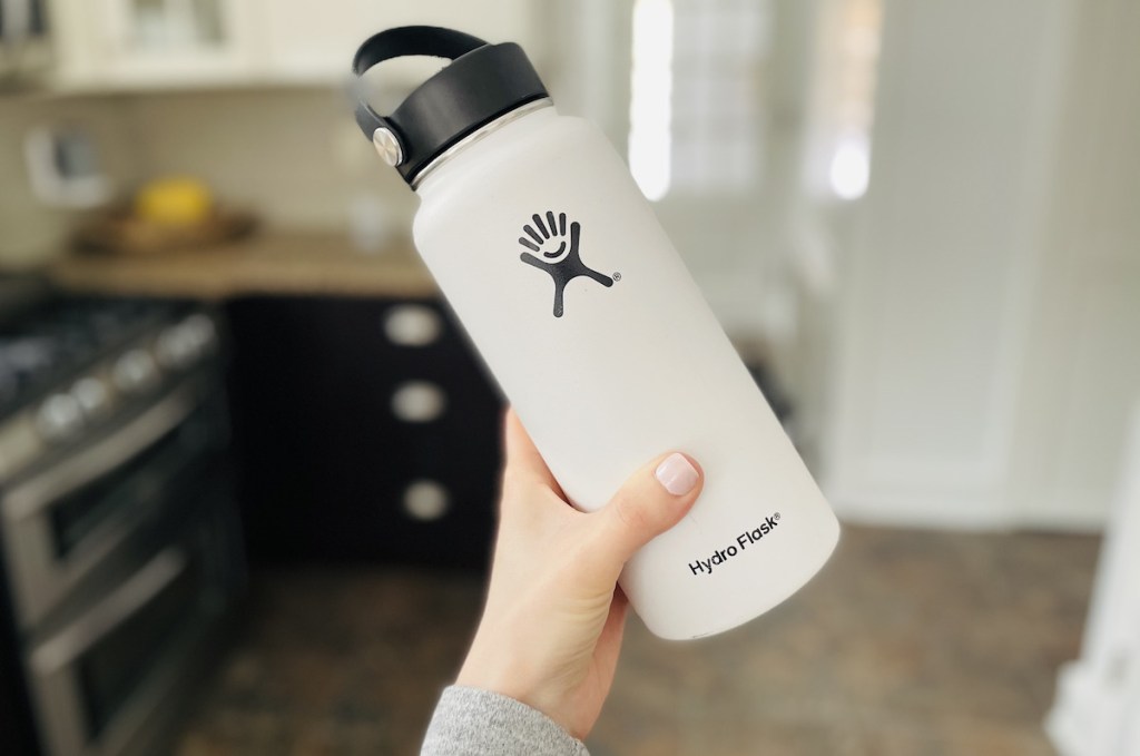 hand holding a white and black hydro flask 
