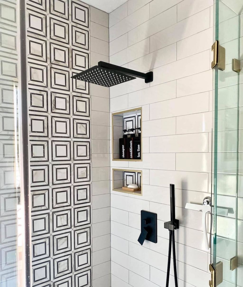 inside of shower with modern square tile and toiletries