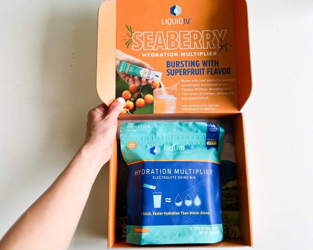 hand opening liquid iv box with bag inside