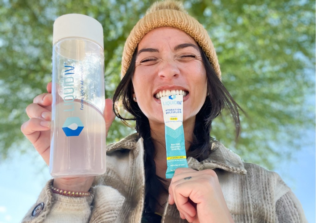 woman biting electrolyte packet